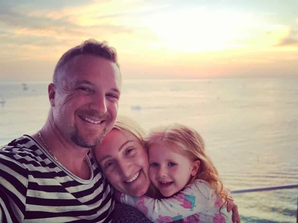 An image of david sharpe and his wife and daughter